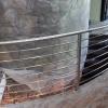 Smooth flowing, contemporary, solid stainless steel curved horizontal and stair rails, for a private residence