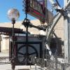 Steampunk themed ride sign support structure straddling the ticket booth with gear match plates by CHR Metals. Design and animated sign by Garage Graphics and Visuals