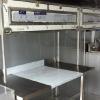 Custom stainless steel table and overhead compartments, with polycarbonate windows that we made and installed in a concession truck.